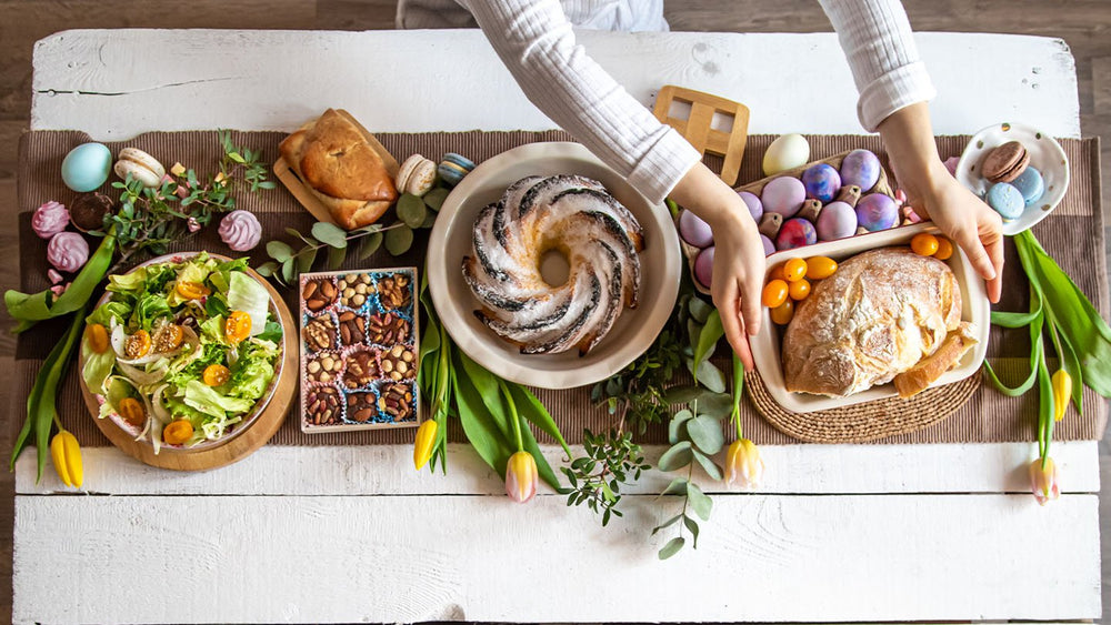 easter meal with easter eggs and spring flowers on a white dinner table