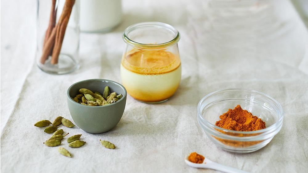 Making golden milk recipe with turmeric, cardamom, and cinnamon.